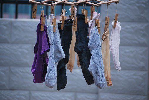 A photo of lots of socks hanging up to dry.  (Photo credit - Pixabay)
